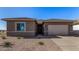 New construction home features a two-car garage, neutral stucco exterior, and low maintenance desert landscaping at 31476 N Hayweather Ln, San Tan Valley, AZ 85143