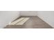 Hallway featuring wood-look tile flooring and neutral paint, offering durability and a clean aesthetic at 31476 N Hayweather Ln, San Tan Valley, AZ 85143