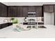 Contemporary kitchen island with a sink, modern faucet, and barstool seating, perfect for entertaining at 31476 N Hayweather Ln, San Tan Valley, AZ 85143
