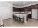 Modern kitchen with dark cabinets, white countertops, a large island, and stainless steel appliances at 31476 N Hayweather Ln, San Tan Valley, AZ 85143