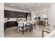 Open kitchen layout with island seating, seamlessly connected to the dining and living areas at 31476 N Hayweather Ln, San Tan Valley, AZ 85143