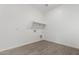 Functional laundry room with tile flooring, built-in shelving, and convenient utility connections at 31476 N Hayweather Ln, San Tan Valley, AZ 85143