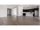 Spacious open-concept living room and kitchen featuring wood-look tile flooring at 31476 N Hayweather Ln, San Tan Valley, AZ 85143