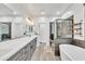 Elegant bathroom with a soaking tub, dual vanities, and modern fixtures providing a spa-like experience at 367 N 157Th Ln, Goodyear, AZ 85338