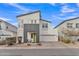 Contemporary two-story home featuring modern architecture, neutral stucco exterior, and low-maintenance desert landscaping at 367 N 157Th Ln, Goodyear, AZ 85338