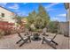 Paver patio with seating area, fire pit and lush flowering landscaping provides a serene outdoor setting at 367 N 157Th Ln, Goodyear, AZ 85338