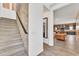 Hallway with staircase, exposed brick, and view into the living area and kitchen with modern finishes at 367 N 157Th Ln, Goodyear, AZ 85338