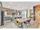 Spacious kitchen and dining area with grey cabinets, exposed brick backsplash, and modern finishes at 367 N 157Th Ln, Goodyear, AZ 85338