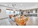 Open concept living room with modern furnishings flows seamlessly into the kitchen and dining area at 367 N 157Th Ln, Goodyear, AZ 85338