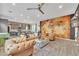 Spacious open-concept living room featuring stylish decor, leather furniture, and a unique world map accent wall at 367 N 157Th Ln, Goodyear, AZ 85338
