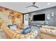 Comfortable living area with leather seating, a large screen TV, and unique decorative accents, perfect for relaxing at 367 N 157Th Ln, Goodyear, AZ 85338