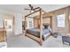 Serene main bedroom boasting a four-poster bed, exposed brick wall, and ample natural light at 367 N 157Th Ln, Goodyear, AZ 85338