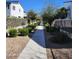 Community walkway landscaped with mature trees and decorative shrubbery between homes at 367 N 157Th Ln, Goodyear, AZ 85338
