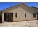 Exterior of the home showing a covered patio and small rectangular windows at 44493 W Cypress Ln, Maricopa, AZ 85138