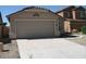 View of the house, with a two-car garage and low maintenance landscaping at 44493 W Cypress Ln, Maricopa, AZ 85138