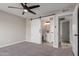 Bedroom with modern sliding barn door and neutral colors at 5934 W Hearn Rd, Glendale, AZ 85306