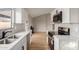 Bright kitchen featuring white cabinets, stainless appliances, and a modern backsplash at 5934 W Hearn Rd, Glendale, AZ 85306