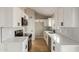 Modern white kitchen with stainless steel appliances and herringbone backsplash at 5934 W Hearn Rd, Glendale, AZ 85306