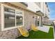 Modern outdoor patio with turf, seating, and large windows overlooking the home at 651 N Ironwood Dr # 1, Apache Junction, AZ 85120