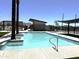 Beautiful community pool with zero entry access, lounge area, and shade structure at 651 N Ironwood Dr # 1, Apache Junction, AZ 85120
