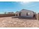 Exterior view of home's backyard featuring dirt, covered patio and block wall at 6722 W Desert Dr, Laveen, AZ 85339