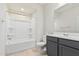Bathroom with shower-tub combination, gray vanity, toilet, mirror and tile flooring at 6722 W Desert Dr, Laveen, AZ 85339