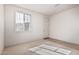 Bright bedroom featuring neutral carpet, large window, and a closet at 6722 W Desert Dr, Laveen, AZ 85339