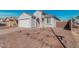 Charming single-story home with desert landscaping, a two-car garage, and a welcoming front entrance at 6722 W Desert Dr, Laveen, AZ 85339