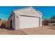 A two-car garage with a brick paver driveway, and low-maintenance desert landscaping at 6722 W Desert Dr, Laveen, AZ 85339
