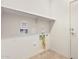 Laundry room with washer and dryer hookups, shelf and tile flooring at 6722 W Desert Dr, Laveen, AZ 85339