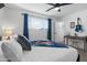 Comfortable bedroom with a ceiling fan, a window, desk, and neutral colors at 7407 E Polk St, Scottsdale, AZ 85257