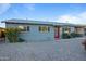 Charming single-story home with a red front door, fresh landscaping, and a well-maintained exterior in a desirable location at 7407 E Polk St, Scottsdale, AZ 85257