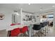 Bright kitchen featuring stainless steel appliances, white cabinets, a large island with seating, and access to the backyard at 7407 E Polk St, Scottsdale, AZ 85257