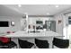 Well-lit kitchen boasts stainless steel appliances, white cabinets, an island with seating, and modern finishes at 7407 E Polk St, Scottsdale, AZ 85257