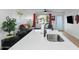 Open-concept living room includes island seating and living area with gray sofa and modern decor at 7407 E Polk St, Scottsdale, AZ 85257