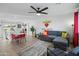 Living area featuring a gray sofa, modern decor, and an open view to the kitchen with island seating at 7407 E Polk St, Scottsdale, AZ 85257