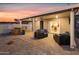 Covered patio with stylish outdoor seating, a full bar, and a sliding glass door, ideal for indoor-outdoor living at 7407 E Polk St, Scottsdale, AZ 85257