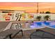 Relaxing poolside view with lounge chairs, vibrant mural, and a refreshing pool, creating a serene outdoor oasis at 7407 E Polk St, Scottsdale, AZ 85257