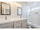 Modern bathroom with double sinks, white marble countertops, and a glass-enclosed shower at 7675 E Mcdonald Dr # 222, Scottsdale, AZ 85250