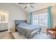 Cozy bedroom featuring a large window, accent chair, and view to the bathroom at 7675 E Mcdonald Dr # 222, Scottsdale, AZ 85250