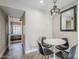 Bright dining area with stylish lighting, a round table, and a view into the bedroom at 7675 E Mcdonald Dr # 222, Scottsdale, AZ 85250
