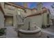 Exterior shot of a tan building with a charming cactus garden in the courtyard at 7675 E Mcdonald Dr # 222, Scottsdale, AZ 85250