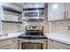 Close up of the kitchen featuring modern appliances and a stylish honeycomb backsplash at 7675 E Mcdonald Dr # 222, Scottsdale, AZ 85250