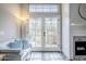 Bright living room featuring glass doors, a shiplap fireplace, and comfortable seating at 7675 E Mcdonald Dr # 222, Scottsdale, AZ 85250
