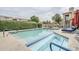 Community pool and spa with lounge chairs and desert landscaping at 7675 E Mcdonald Dr # 222, Scottsdale, AZ 85250