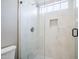 This bathroom shower is updated with a tile surround, soap niche, and glass doors at 7675 E Mcdonald Dr # 222, Scottsdale, AZ 85250