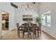 Dining room with vaulted ceiling, wood table with seating for six, and view of the backyard pool at 8420 E San Candido Dr, Scottsdale, AZ 85258