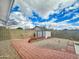 Large backyard with brick patio, gravel, privacy wall, and storage shed at 8611 W Village Dr, Peoria, AZ 85382