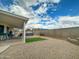 Backyard area featuring a covered patio and hot tub with ample yard space at 8611 W Village Dr, Peoria, AZ 85382
