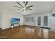 Spacious living room with wood floors, bright windows, and french doors leading to the backyard at 8611 W Village Dr, Peoria, AZ 85382